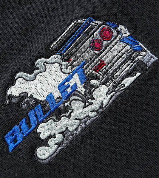 Embroidered engine with exhaust smoke and blue 'BUILD IT' text on black fabric